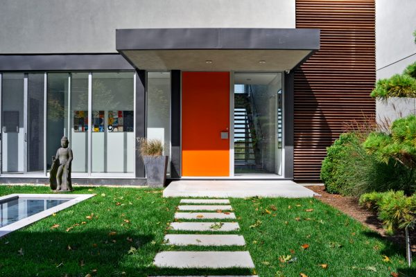 complement an orange front door with floor-to-ceiling windows in this limestone-floored entryway