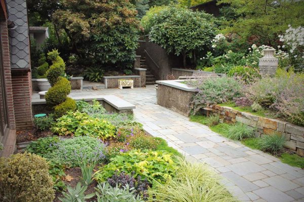 consider tumbled connecticut bluestone with retaining wall cap for a craftsman inspired landscape idea