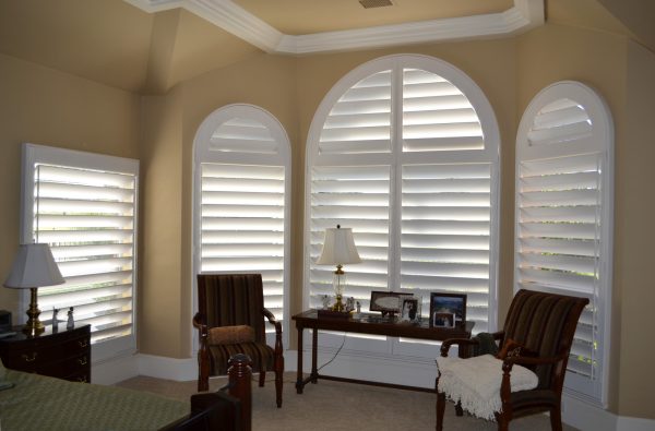 go for 5-1/4" horizon panels from o'hair as the shutters for arched windows in a traditional bedroom