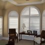 go for 5-1/4" horizon panels from o'hair as the shutters for arched windows in a traditional bedroom