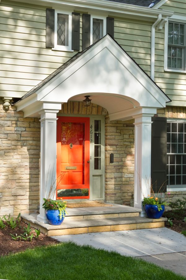 go for an orange front door under a traditional portico for an elegant and timeless appeal