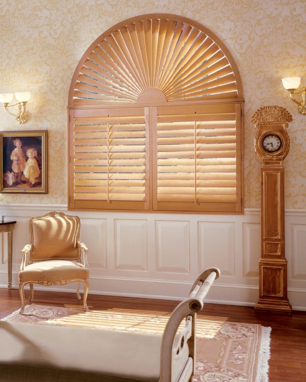 induce the mid-century charm with stained wood shutters for your arched windows