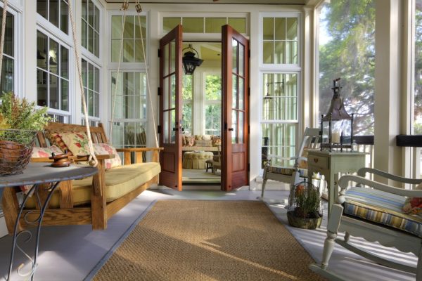pair mahogany french doors with transom for a cozy and timeless screened-in porch