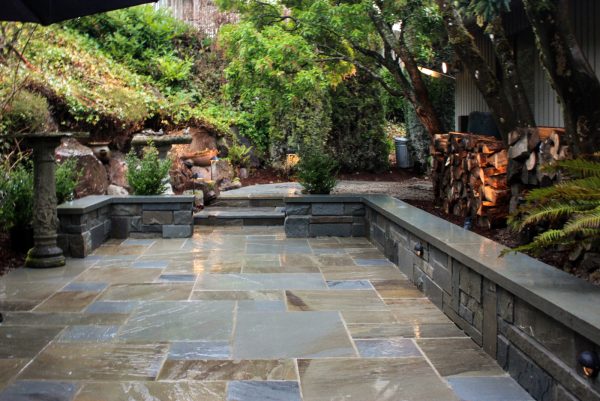 this retaining wall design can create a timeless courtyard with a natural bluestone cap