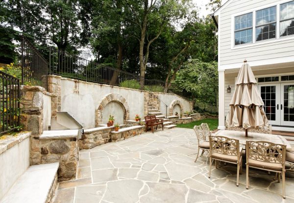 this traditional retaining wall cap idea has a charming and rustic appeal with stone floors and antique furnishing