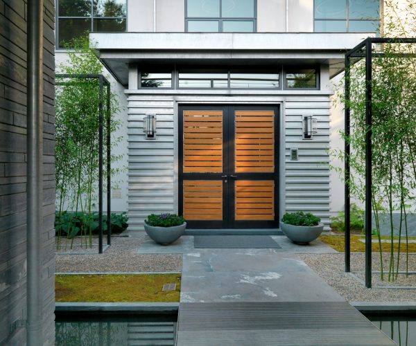 try a large double front door with black and orange colors for a modern entryway
