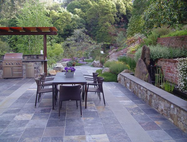 using basalt for the retaining wall cap is a brilliant idea for a contemporary patio vibe