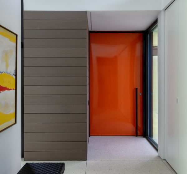 white concrete floor can be a cozy welcome after the bright and eye-catching orange front door