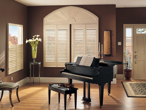 white plantation shutters for arched windows can look beautiful in an elegant, dark-themed living room