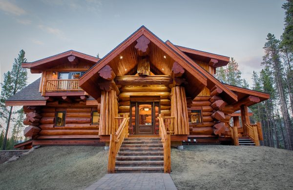 build a striking log cabin featuring glass-paneled front doors and a stunning raised patio
