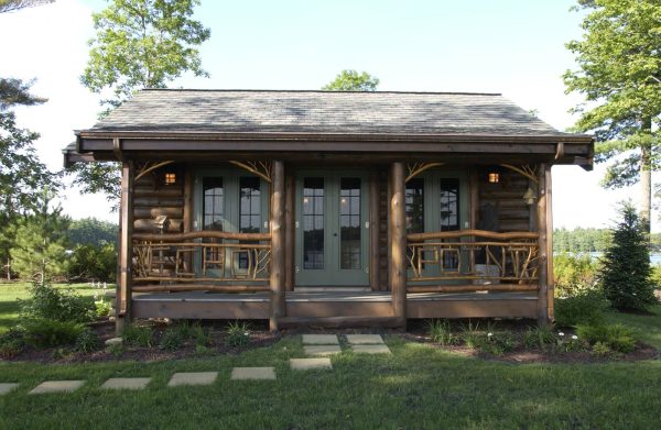 complete a lovely brown log cabin with green french front doors