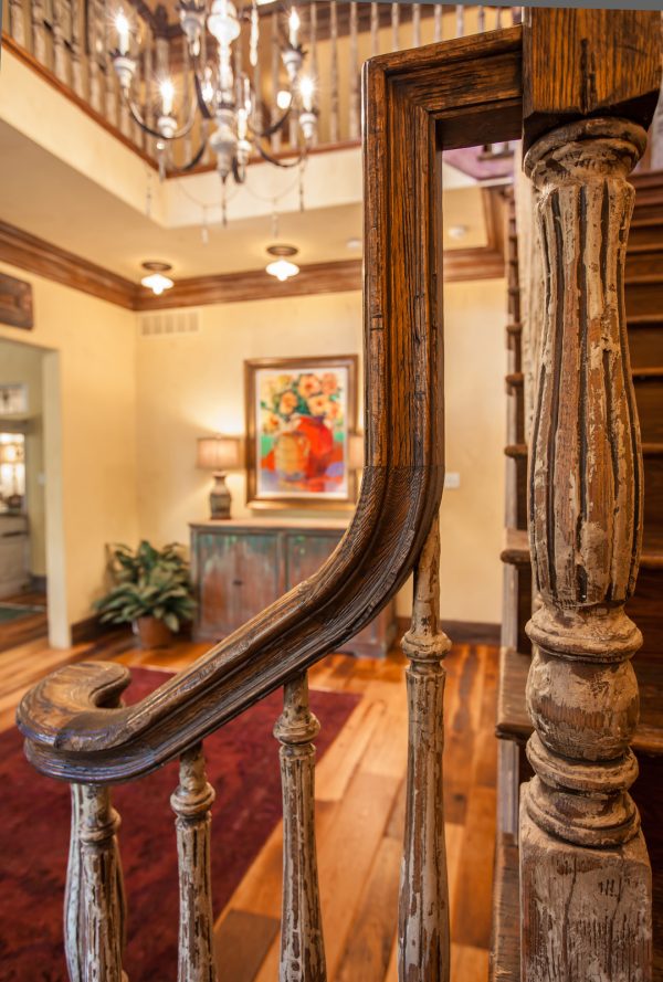 distress dark-stained turned balusters for the quintessential rustic indoor wood stair railing design