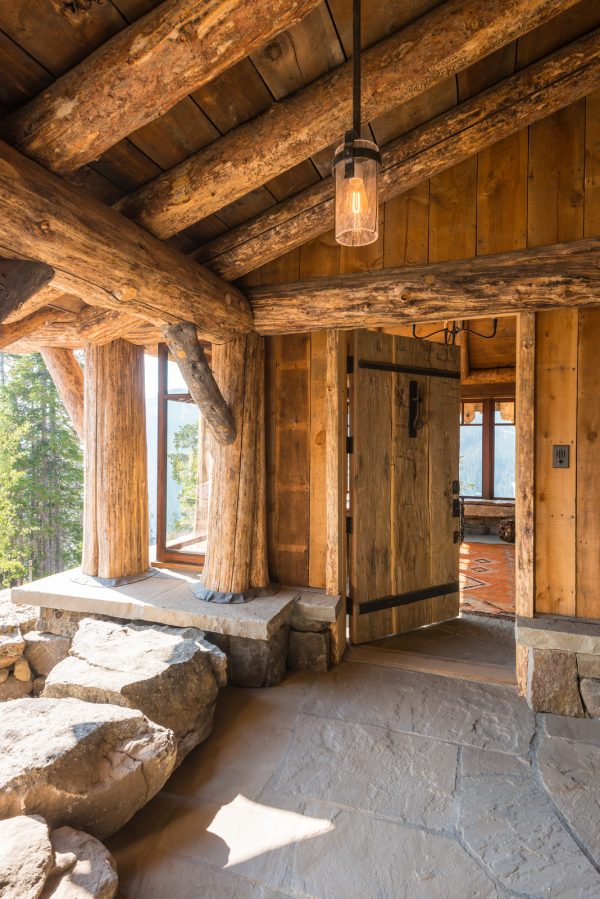 embrace the mountain inspired log cabin using a rustic wood front door