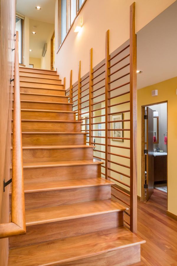 go for a contemporary southwest look with this indoor horizontal wood stair railing design and wooden risers