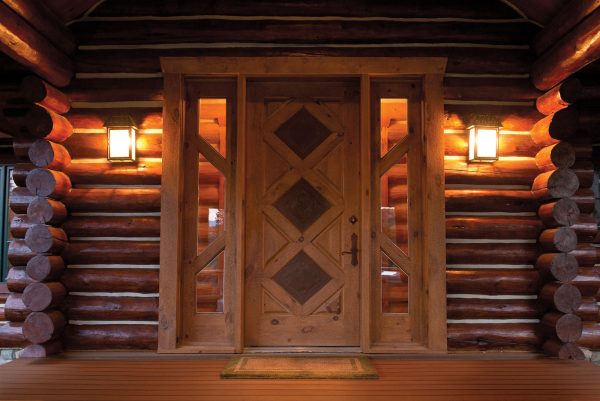 go rustic with this teak-stained log cabin front door and warm pendant lights