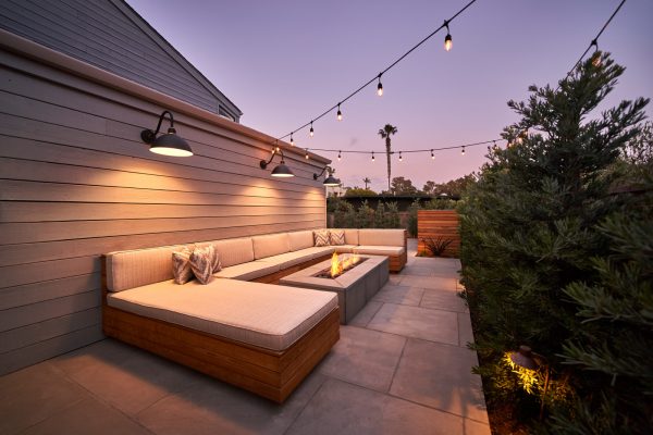 install bluestone pavers and a u-shaped sofa for a cozy small backyard even with no grass