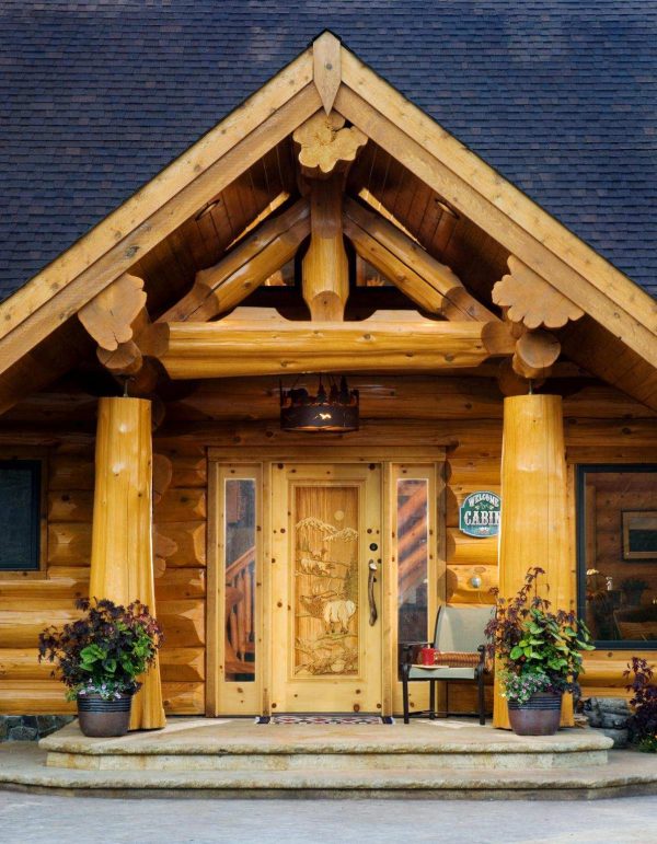jazz up a light wood log cabin front door with plants and a simple chair