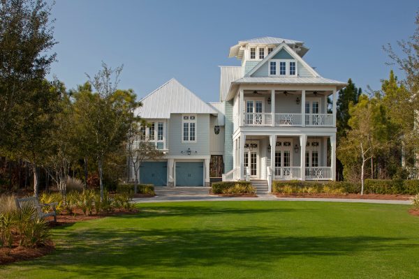 this gorgeous beach-style blue-gray house features sherwin williams misty and moody blue garage door