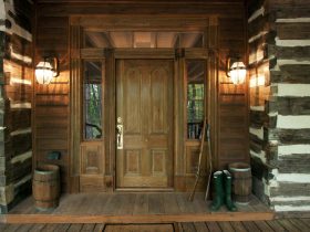 this log cabin looks quintessentially rustic with a medium wood front door