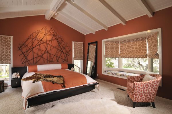 try a striking combination with audubon russet from benjamin moore orange wall color and oyster carpet for the bedroom
