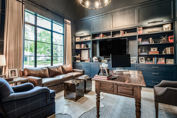 add a leather sofa in a large navy blue office with sherwin williams’ gale force for the ultimate cozy atmosphere