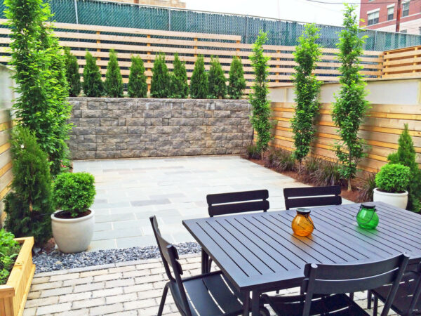 add plexiglass border above horizontal cedar fence on retaining wall for a contemporary landscape