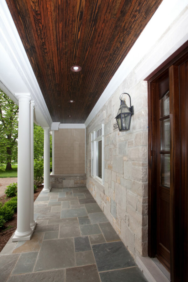 build a classic and attractive front porch featuring slate tiles, stone walls, and deep wood surfaces
