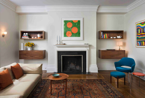 combine floating walnut shelves with cabinets next to fireplace for added storage and depth in a modern living room