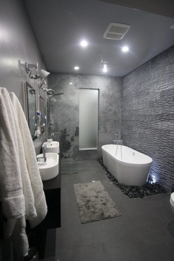 combine japanese marble and porcelain tiles in a dark grey bathroom for a zen atmosphere