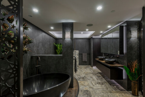 decorate a modern and attractive dark grey bathroom featuring live plants and travertine floors