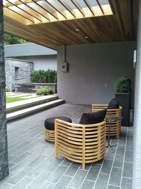 go for a natural stone slab for your front porch tile and install a trendy roof extension for a contemporary charm