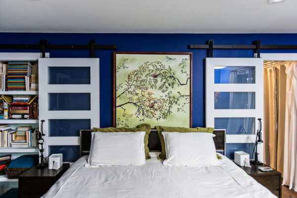 incorporate modern door fixtures for a unique bookcase and entrance in your royal blue bedroom