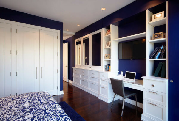 jazz up a royal blue bedroom with a built-in desk for the best functionality and space-saving trick