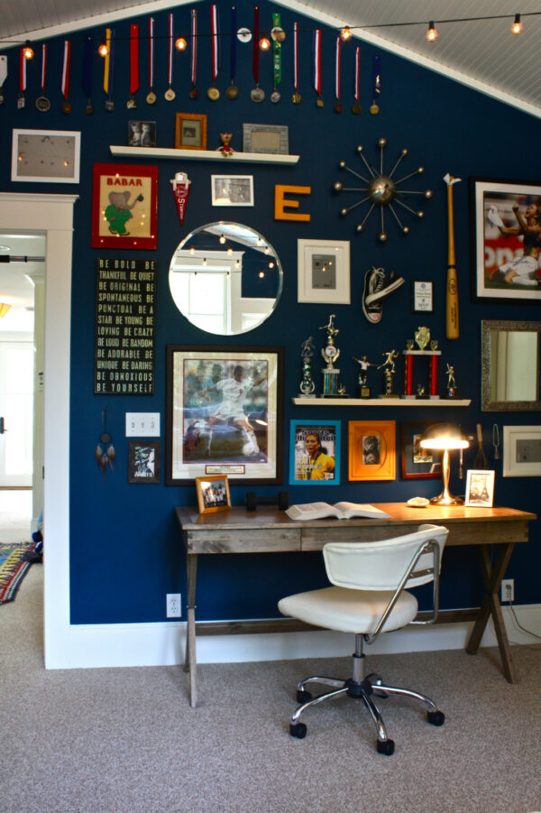 jazz up the navy blue office space in the bedroom using benjamin moore’s adriatic sea and a homemade wall of fame
