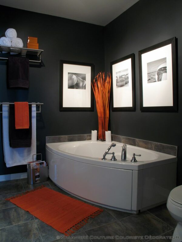 place monochromatic photos and striking red accents in your dark grey bathroom for a dazzling interior