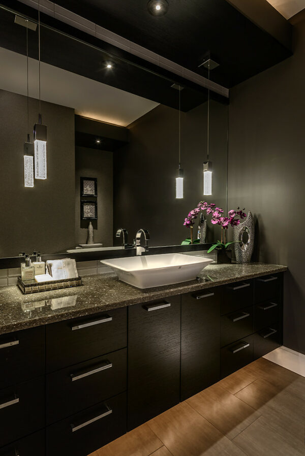 purple flowers and a wall-to-wall mirror can complete your dark grey bathroom for a luxurious appeal