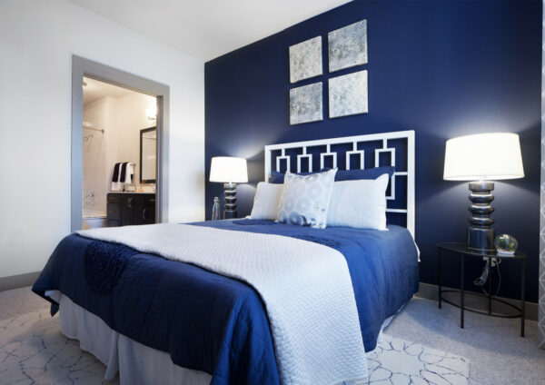 sherwin williams 6244 naval is a lovely accent wall in a royal blue bedroom with modern interior touches