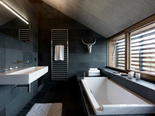 this contemporary dark grey bathroom looks fetching with a white glacier sink and corian countertops
