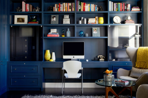 this custom desk and bookshelf unit looks gorgeous and eclectic in a navy blue office