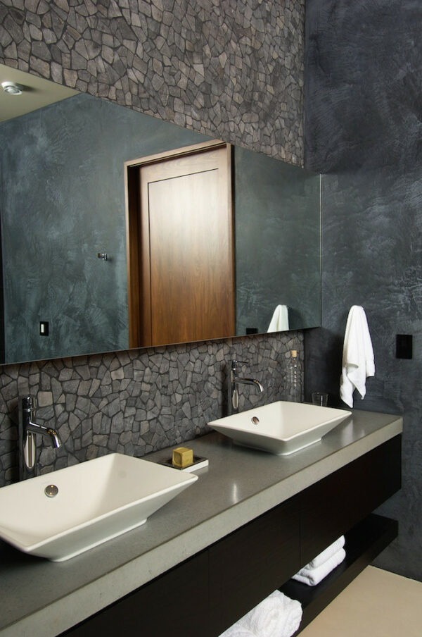 this farmhouse inspired dark grey bathroom features customized vanity and stunning mosaic tile walls