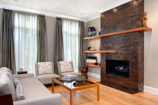 try teak floating shelves next to the living room fireplace in an interesting, asymmetrical shape to create artistic intrigue