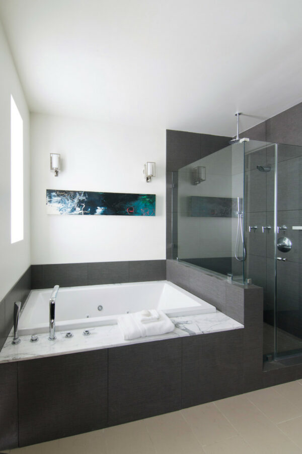 use emser tiles to contrast the white walls for a dark grey bathroom that feels bright and relaxing