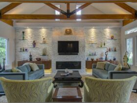 use quartz stone to complement floating glass shelves next to fireplace for an elegant mediterranean style living room
