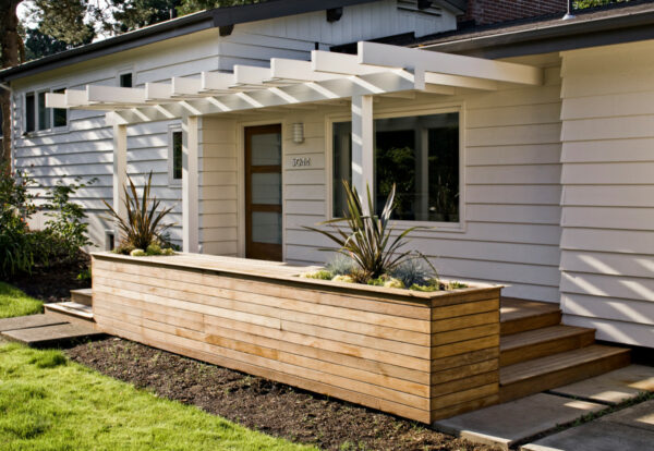add planters for extra privacy and flair near a front door pergola in your contemporary entryway