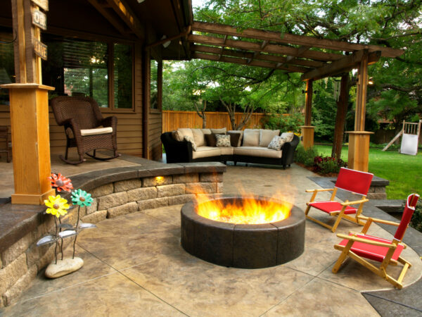 build a relaxing stamped concrete patio with a fire pit and various outdoor seating