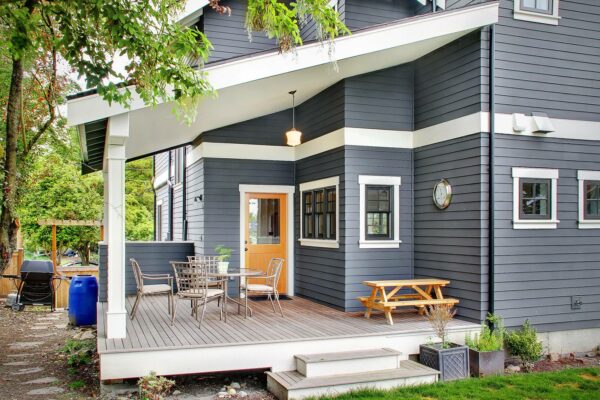 combine grey and white in a small backyard deck for a traditional craftsman-inspired space