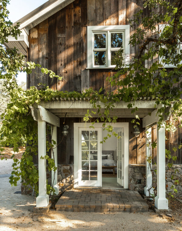 create a dreamy fairy tale vibe by planting vines around your front door pergola and wood siding