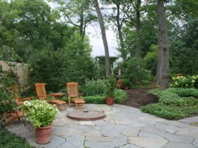 create a traditional and tranquil mood using irregular bluestone on the patio and a fire pit