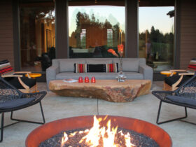 furnish a stamped concrete patio with a custom fire pit and crushed granite and rustic rock table