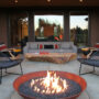 furnish a stamped concrete patio with a custom fire pit and crushed granite and rustic rock table